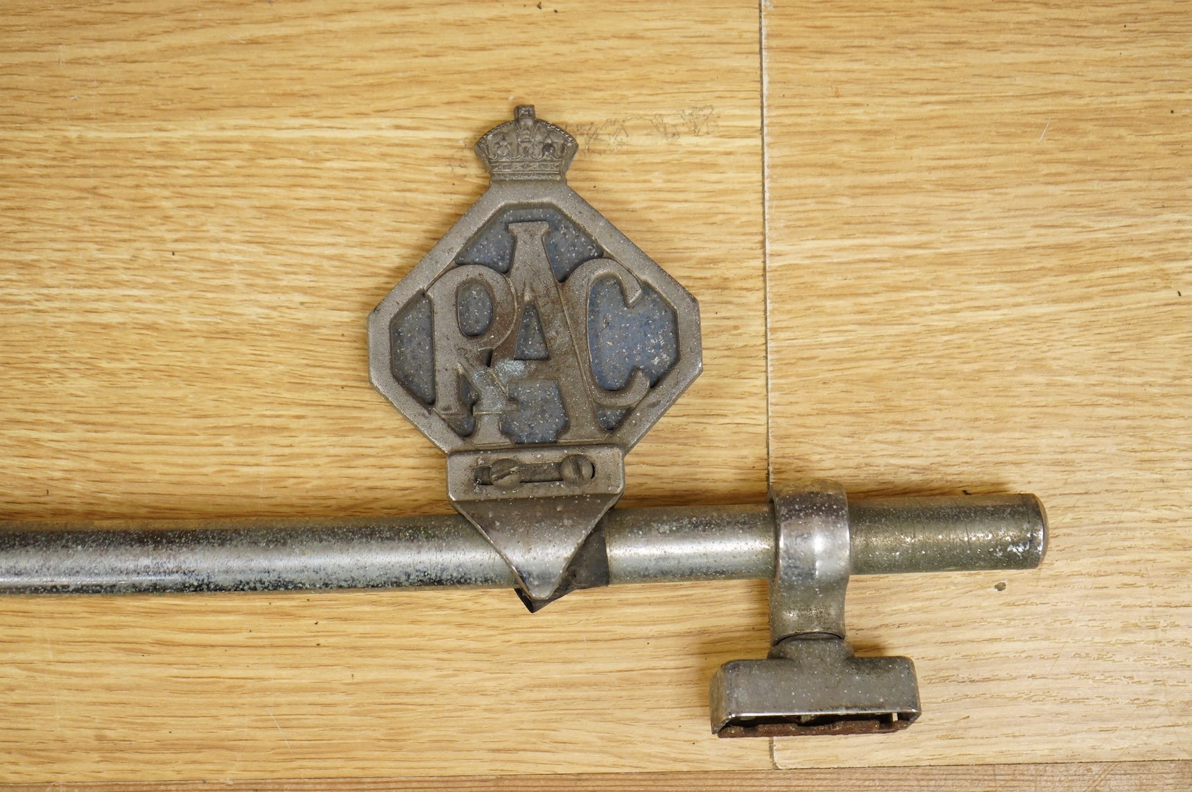 Three car badges to include RAC and AA, mounted on a bar, 67cm in length
